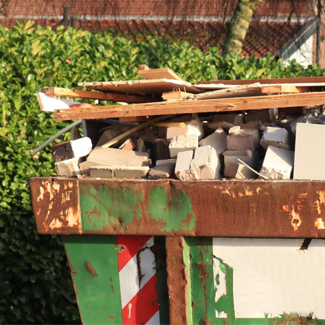 close up of a full dumpster with building materials