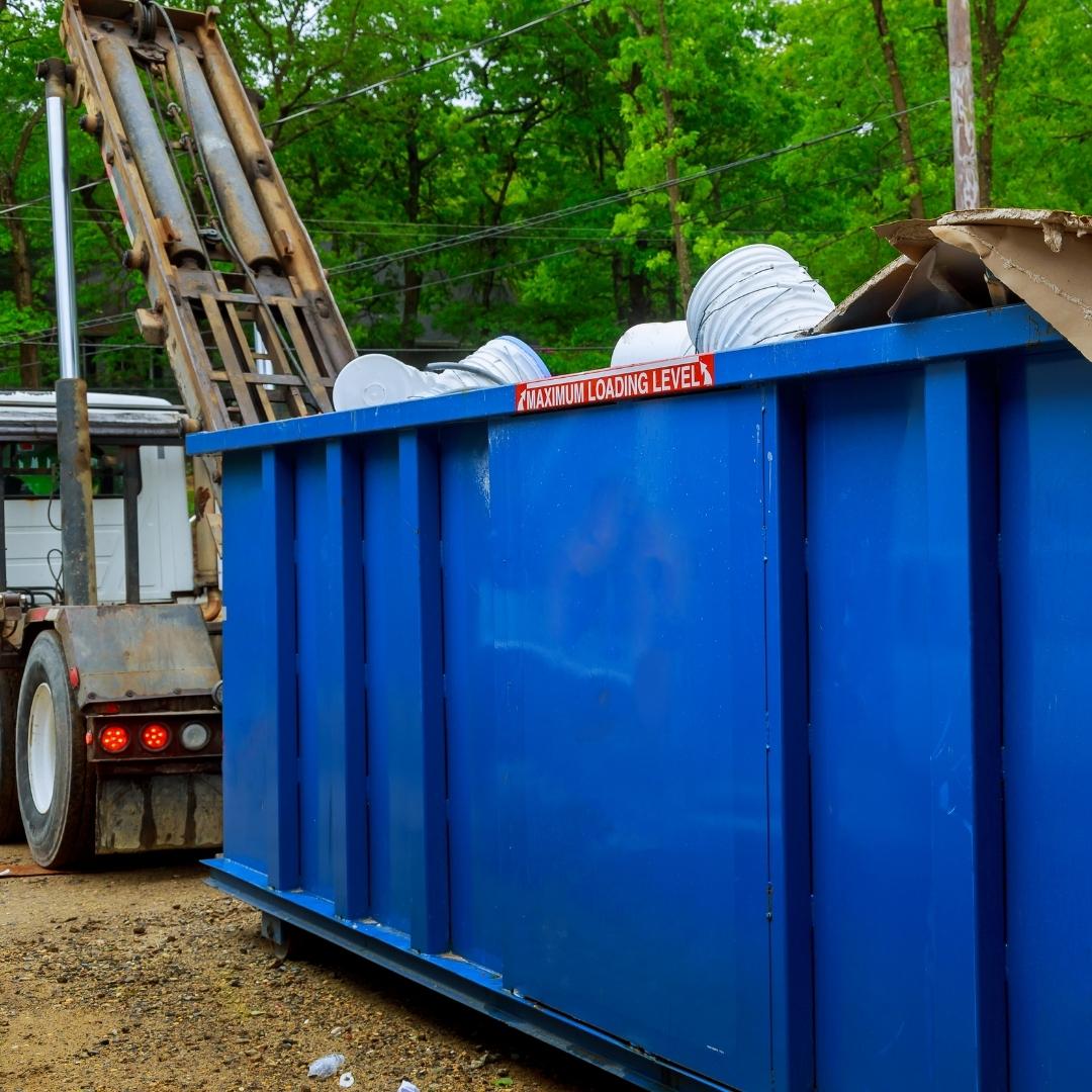 Dumpster being unloaded from a truck